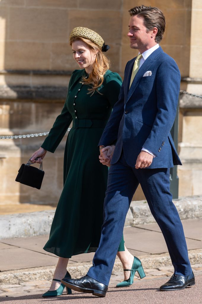 The royal couple smiles as they arrive at St. George’s Chapel. Beatrice styles her Beulah London dress with matching green Emilia Wickstead Onna heels and a glittering pillbox headband.