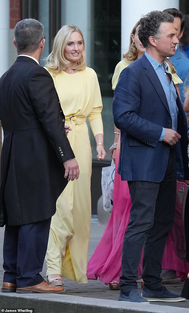 An usher (left) carries out his wedding duties, directing guests Lucy Lanigan-O'Keeffe and her husband Thomas Van Straubenzee as they make their way to the evening party