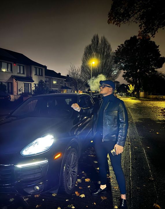 Mihail Trofim posing with a Porsche SU