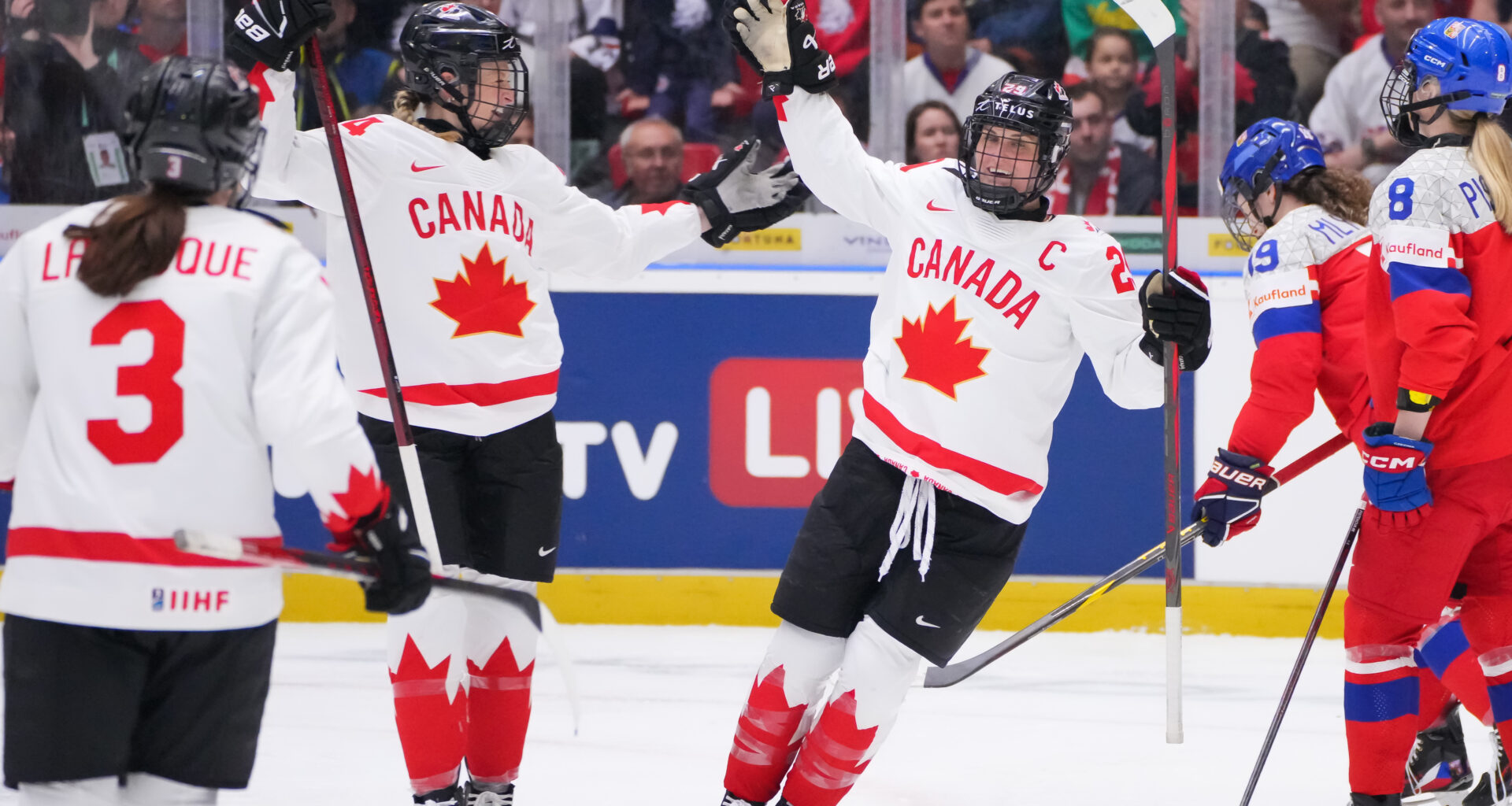 Poulin leads Canada over hosts