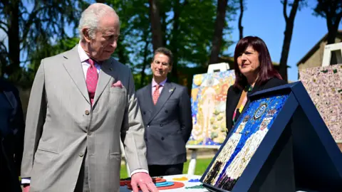 Reuters King Charles III observes mosaic of his coronation outside the Basilica di San Vitale