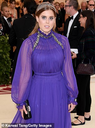 At the Met Gala red carpet 2018 Princess Beatrice was wearing a purple long-sleeved gown with golden accents