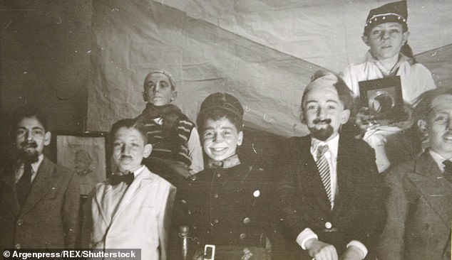 Jorge at a School theatre presentation as a waiter, wearing a white jacket and black bow tie