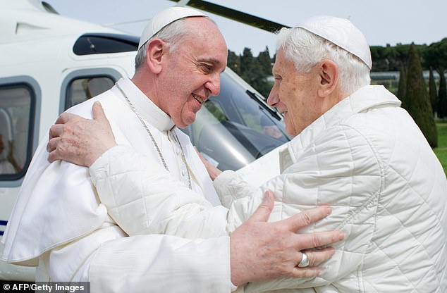 Pope emeritus Benedict XVI greets his successor Pope Francis upon his arrival at the heliport in Castel Gandolfo, the Pontiff's summer residence outside in Rome