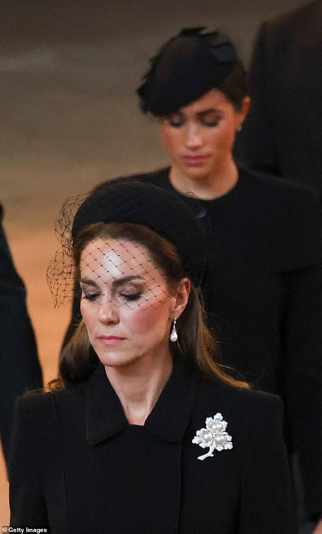 Kate and Meghan walk in procession with the coffin of Queen Elizabeth as it arrives at Westminster Hall from Buckingham Palace for her lying in state, on September 14, 2022