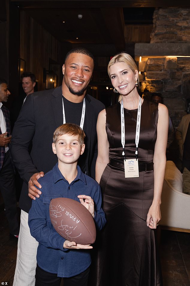 Saquon Barkley takes a photograph with Ivanka Trump and her 11-year-old son Joseph