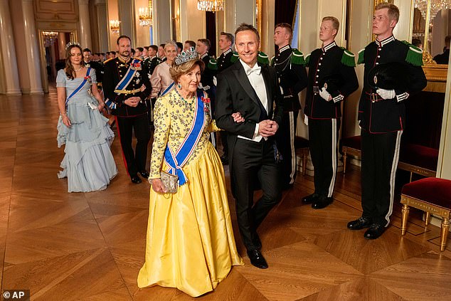 King Harald stepped out with Halla - who donned a striking navy frock with a bedazzled neckline - while Queen Sonja, 87, (front) who was stunning in a sunny yellow ensemble, walked along next to the President's husband, Bjorn