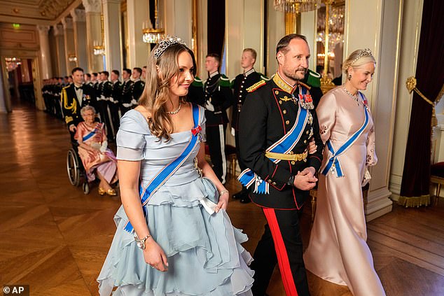 The young royal, 21, (left) was the image of elegance in a pastel blue dress with a ruffled bodice - which she adorned with various regalia, including a stunning tiara