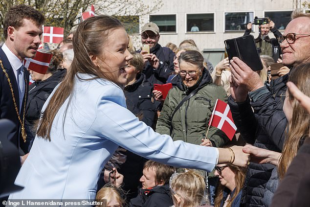 The family were greeted by well-wishers in the square, with many eagerly grabbing pictures of the moment and reaching to shake hands with Isabella