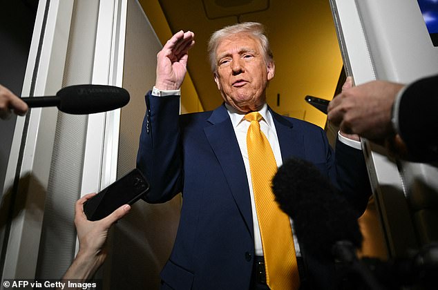 Trump speaks to reporters during the short flight from Palm Beach to Miami for the fight