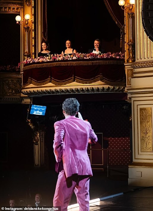 Isabella, sat between her parents, enjoyed the performances while sat on a balcony above the stage