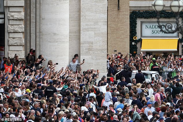 Faithful react, as Pope Francis travels on the Pope mobile, on the day the 'Urbi et Orbi'