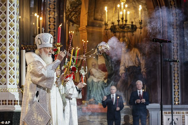 Russian Orthodox Church Patriarch Kirill, left, leads the Orthodox Easter service as Russian President Vladimir Putin, left, and Moscow Mayor Sergei Sobyanin stand near at Christ the Saviour Cathedral in Moscow, Russia, on Sunday, April 20