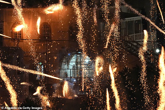 Fiery streaks of handmade rockets lit up the night sky over the village of Vrontados on the island of Chios