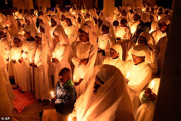 Christian faithful of the Legio Maria African Mission, attend the Easter vigil Mass in the informal settlement of Kibera in Nairobi, Kenya