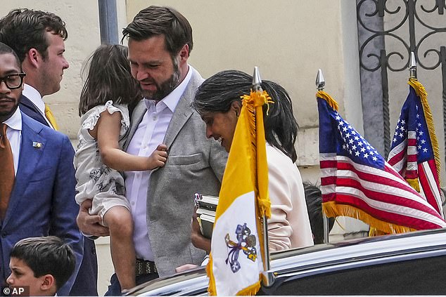 Vance, center, his wife Usha and their children, Vivek, left, and Maribel, back to camera, arrive at the Basilica of Saint Paul