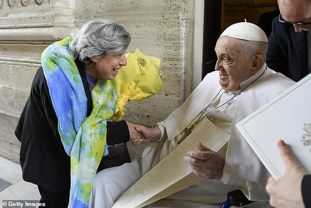 The Pope smiled as he greeted a woman during the Easter Mass in St. Peter's Square yesterday