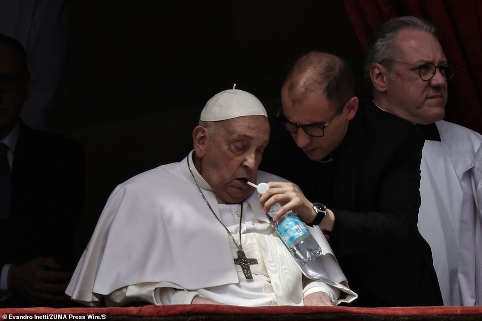 A man can be seen holding a bottle of water with a straw to the Pope's mouth