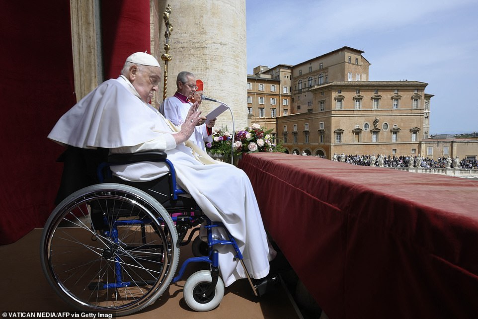 The Pope was sitting in a wheelchair as he waved to the crowd from the main balcony of St Peter's basilica while giving his Urbi et Orbi message