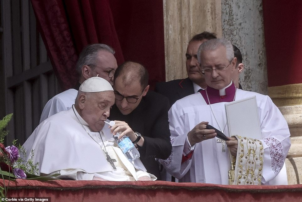 Pope Francis is helped to drink water during the Urbi et Orbi Message to the World at the central Loggia of St. Peter's Basilica, on April 20, 2025