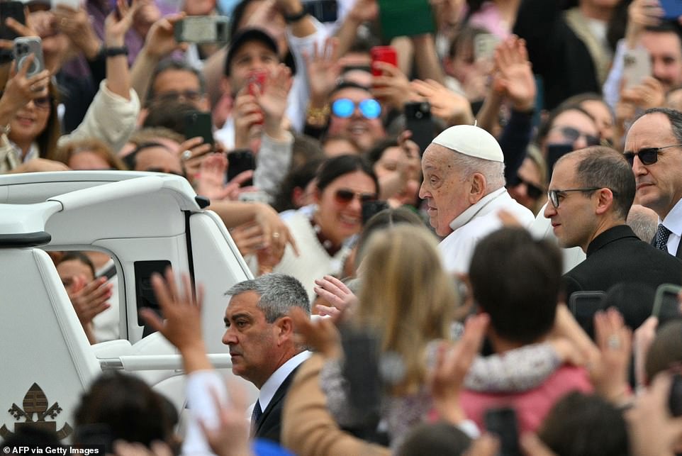 Pope Francis greets the crowd from the popemobile after the Easter mass