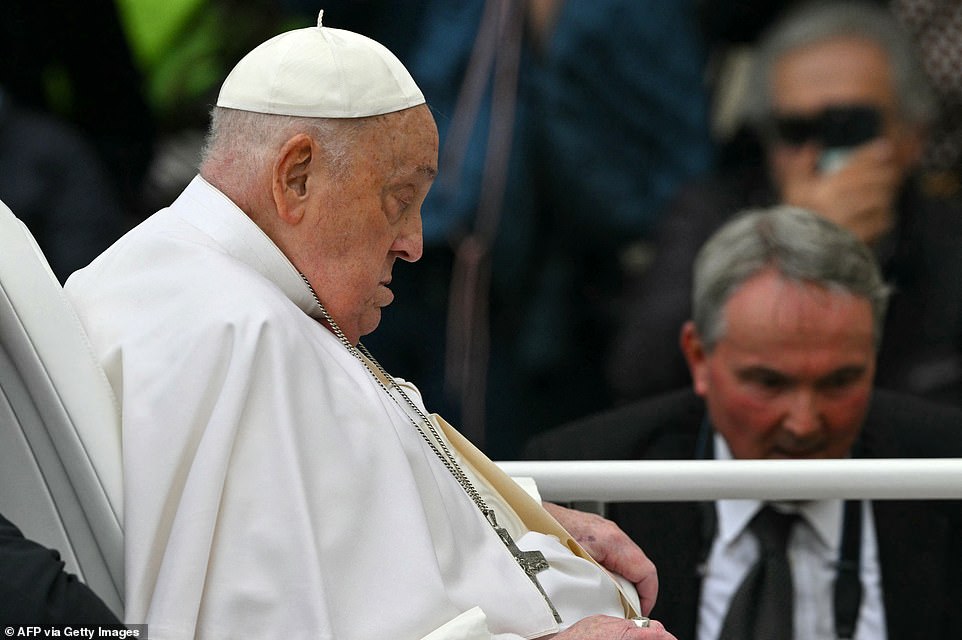 Pope Francis greets the crowd from the Popemobile after the Easter mass