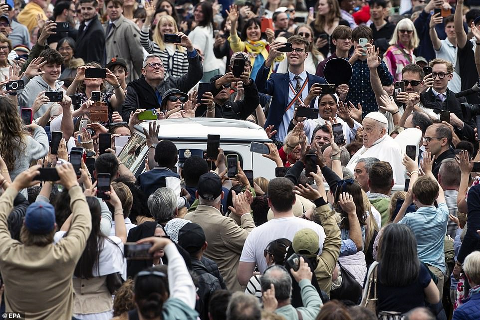 Pope Francis greets the faithful after the Urbi et Orbi blessing following the Easter Mass in Saint Peter's Square