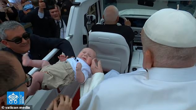 Pope Francis blessed babies as he was driven through St Peter's Square yesterday