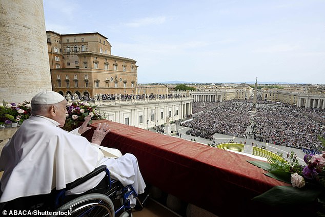 Pope Francis delivers his Easter message and blessing Urbi et Orbi - 'To the City and the World' - via an aide as he sits and watches from the balcony of Saint Peter's basilica yesterday