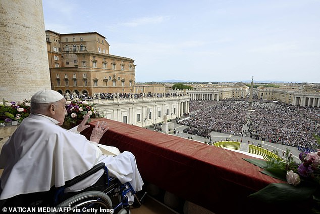 The Pope looks out on thousands of people who gathered outside St Peter's basilica for Easter Sunday mass yesterday