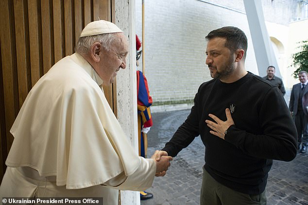 Ukrainian President Volodymyr Zelensky shakes hands with Pope Francis during a meeting at the Vatican in May 2023