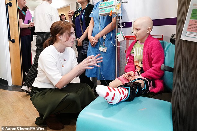 Princess Eugenie is pictured chatting to a cancer patient Belle Tucker during the trip on Wednesday