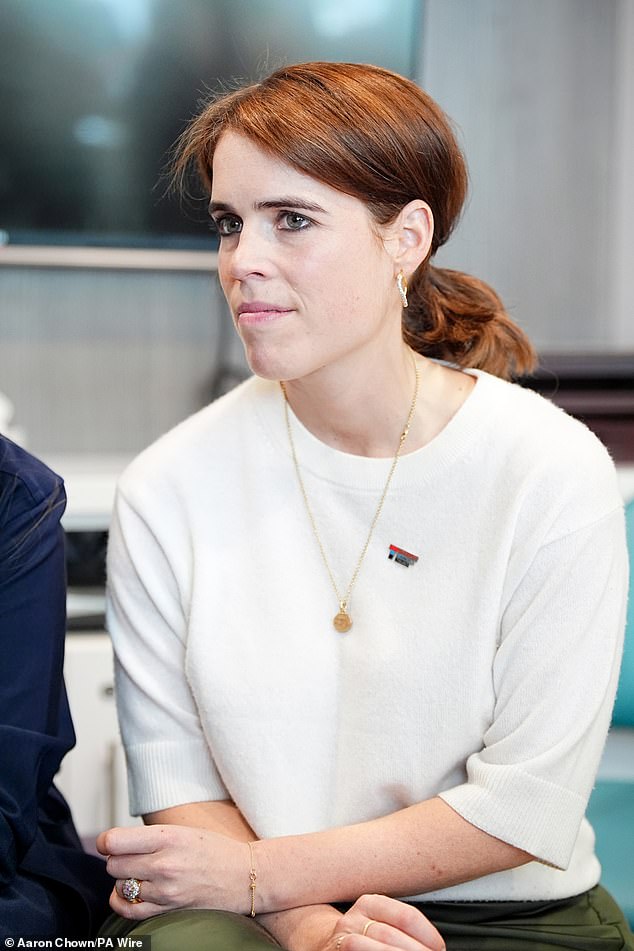 Princess Eugenie donned smoky eye makeup as she is pictured listening intently during the visit on Wednesday