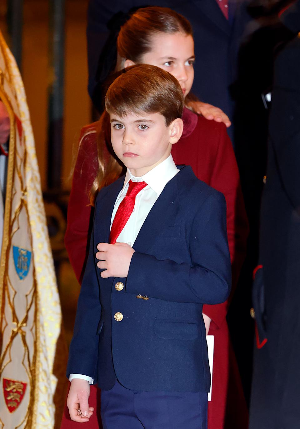 Prince Louis wearing a blue suit and red tie in December 2024
