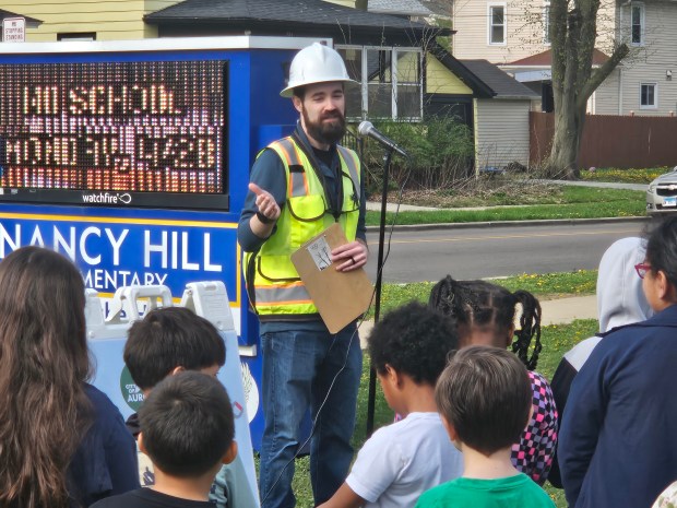 Nick Day, vegetation program manager for ComEd, talks to students during an Arbor Day ceremony Friday at Hill Elementary School in Aurora. (David Sharos / For The Beacon--News)