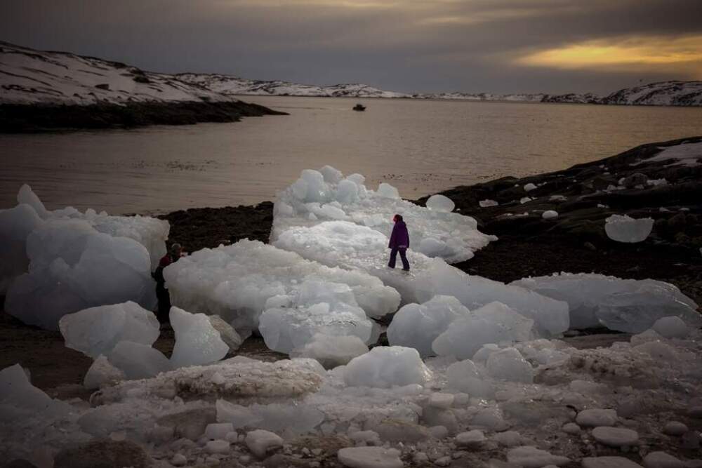 A child walks on top of pieces of ice in Nuuk, Greenland on Feb. 16, 2025. (Emilio Morenatti/AP)