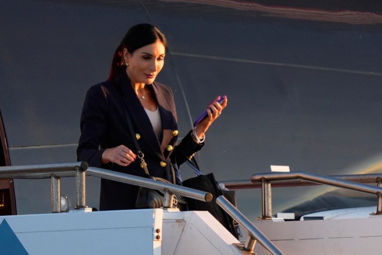Laura Loomer descends an airplane staircase