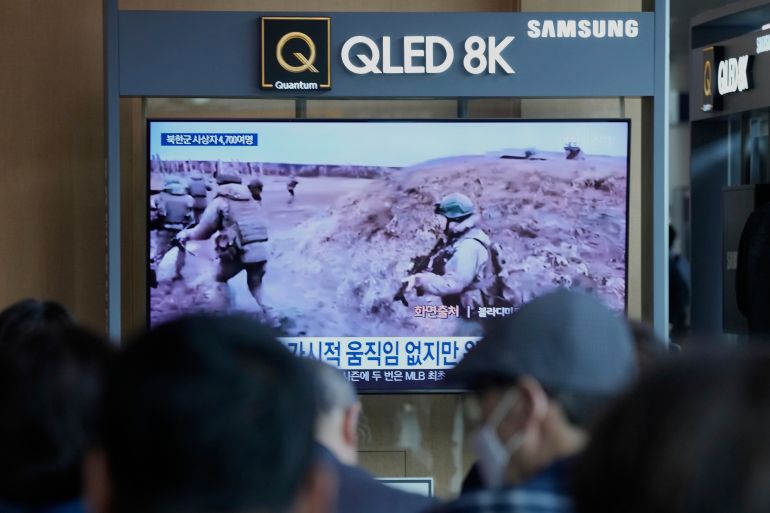 People watch in TV an undated image, released in a Telegram post by Vladimir Solovyov, a presenter for Russian state television, of North Korean soldiers undergoing combat training in Russia, during a news program at the Seoul Railway Station in Seoul, South Korea, Wednesday, April 30, 2025. (AP Photo/Ahn Young-joon)
