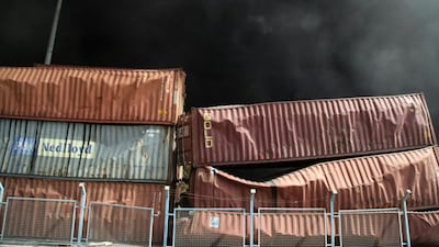 Smoke rising behind damaged containers following an explosion at the Shahid Rajaee port dock, south-west of Bandar Abbas. AFP