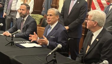 Gov. Greg Abbott (center) talks about business regulations as he signs Senate Bill 14, which creates a government entity focused on eliminating red tape for businesses.