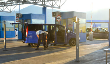 A van is stopped and checked by two inspectors at the border crossing at Ivanica between Bosnia and Herzegovina and Croatia.