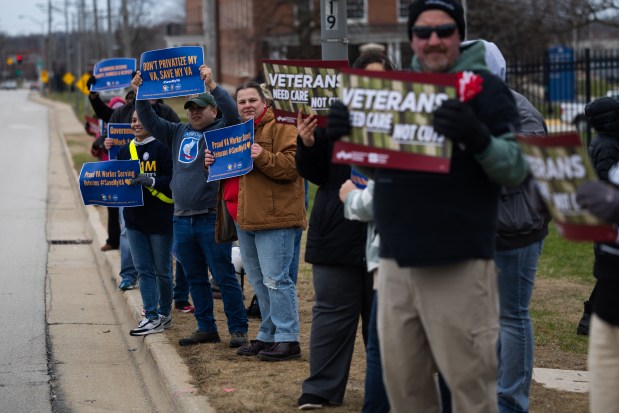 People attend a rally and press conference hosted by the American Federation of Government Employees Local 2107, representing Department of Veterans Affairs employees, outside of Captain James A. Lovell Federal Health Care Center to protest attacks on the federal workforce on April 4, 2025, in North Chicago. (Audrey Richardson/Chicago Tribune)