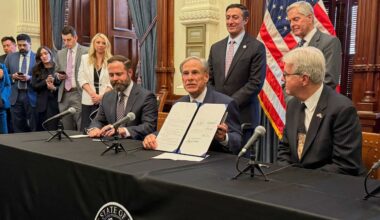 Texas Gov. Greg Abbott, center, holds a newly signed bill creating the Texas Regulatory Efficiency Office during a ceremony inside the state Capitol on Wednesday, April 23, 2025, in Austin, Texas. (AP Photo/Nadia Lathan)