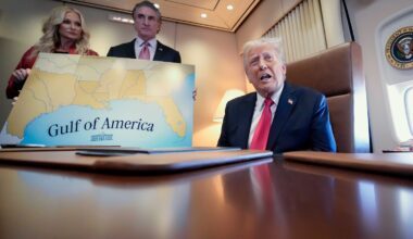 President Donald Trump, on right, accompanied by Interior Secretary Doug Burgum and Burgum's wife Kathryn Burgum, who are holding a map of the 'Gulf of America,' aboard Air Force One.