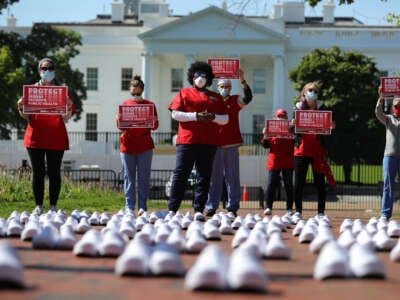 Members of National Nurses United stand in protest among empty shoes representing nurses that they say have died from COVID-19, in Lafayette Park across from the White House, on May 7, 2020, in Washington, D.C.