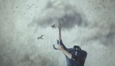 Concept of losing your mind; headless man holding up umbrella made of clouds