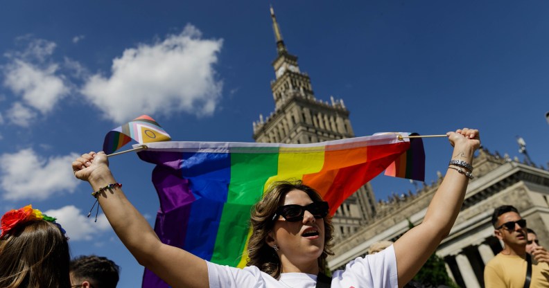 A participant holds a rainbow flag before the procession in Warsaw, Poland.