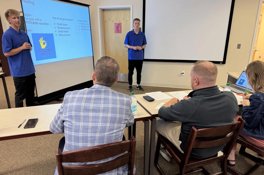 Senior Tanner Wasden and Junior Logan Nelson explain a window washing business to judges | Nichole Stanford, EastIdahoNews.com