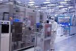 A photo from November 2021 shows employees in cleanroom "bunny suits" working at Intel's D1X factory in Hillsboro, Oregon. 