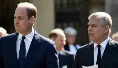 Prince William and Prince Andrew wearing suits holding programs at a church service